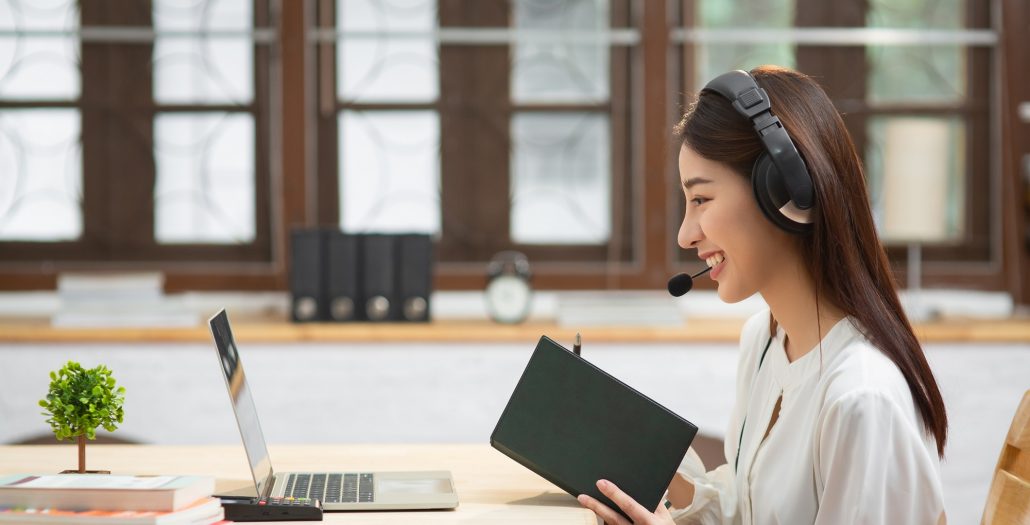 Happy chinese business woman with headphones Happy chinese business woman with headphones